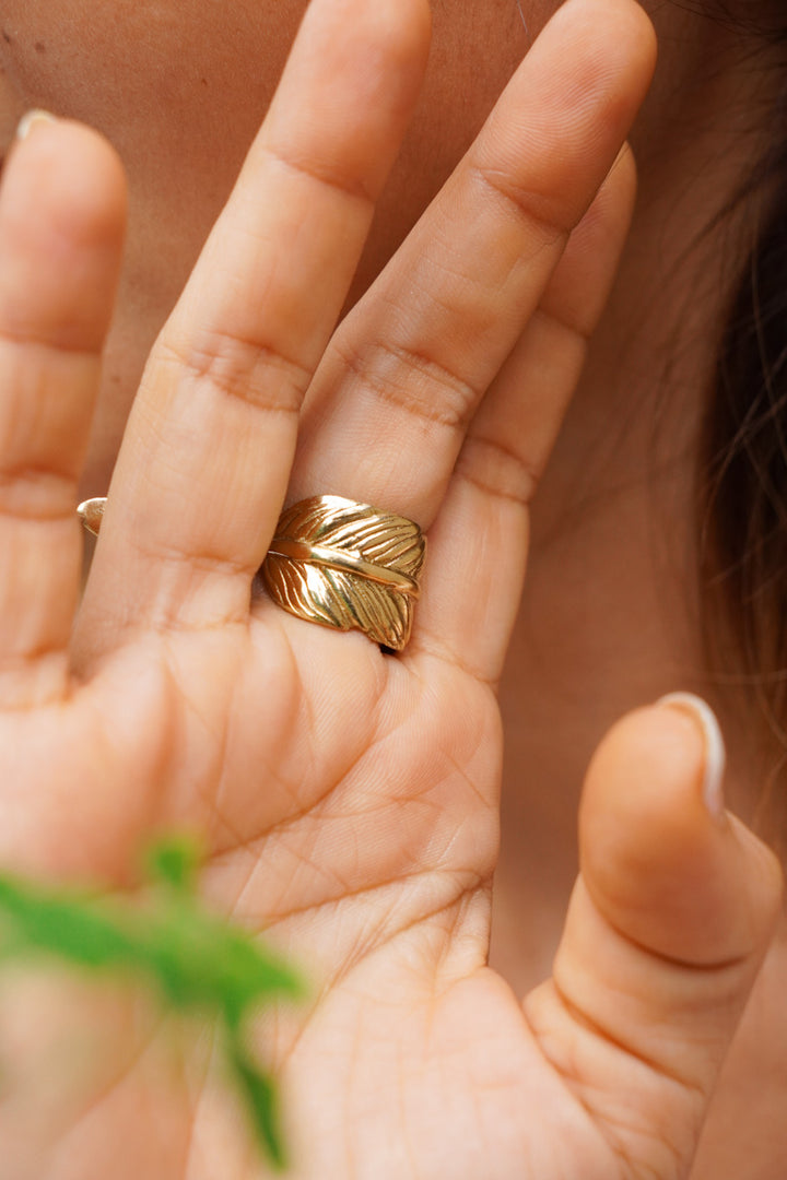 Feather wrap adjustable brass ring. Size 5-7