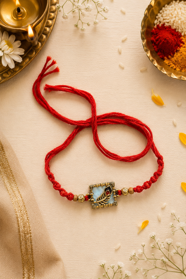 Mor pankh rakhi- mix alloy with rice, haldi & kum kum dibbi gift pack