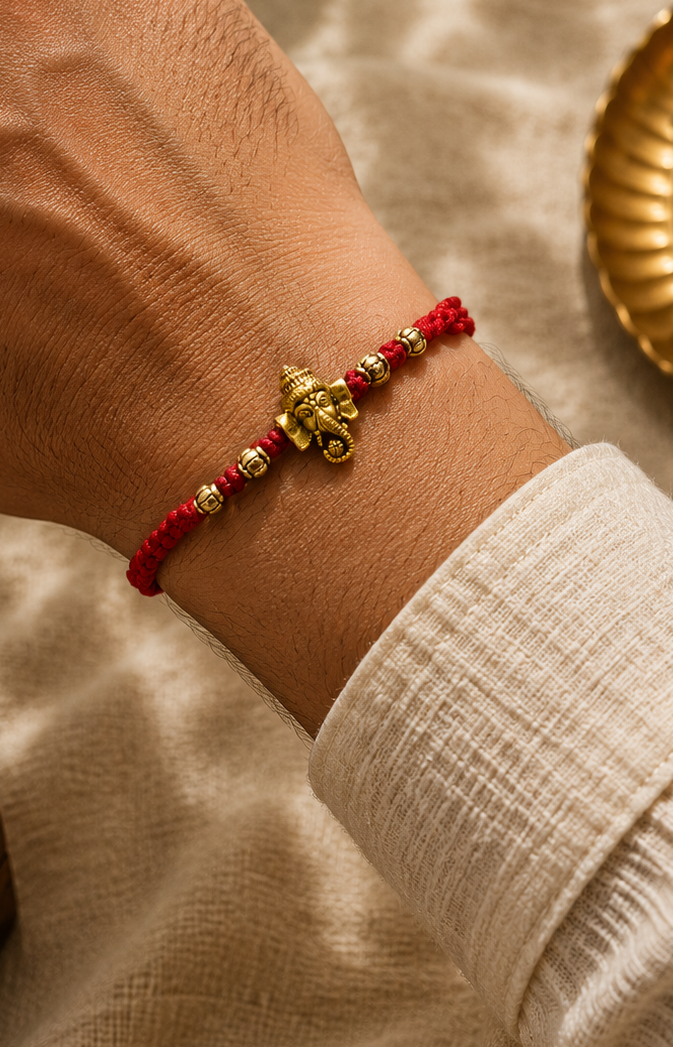Ganesh Om rakhi in mauli thread with rice, haldi & kum kum dibbi gift pack.