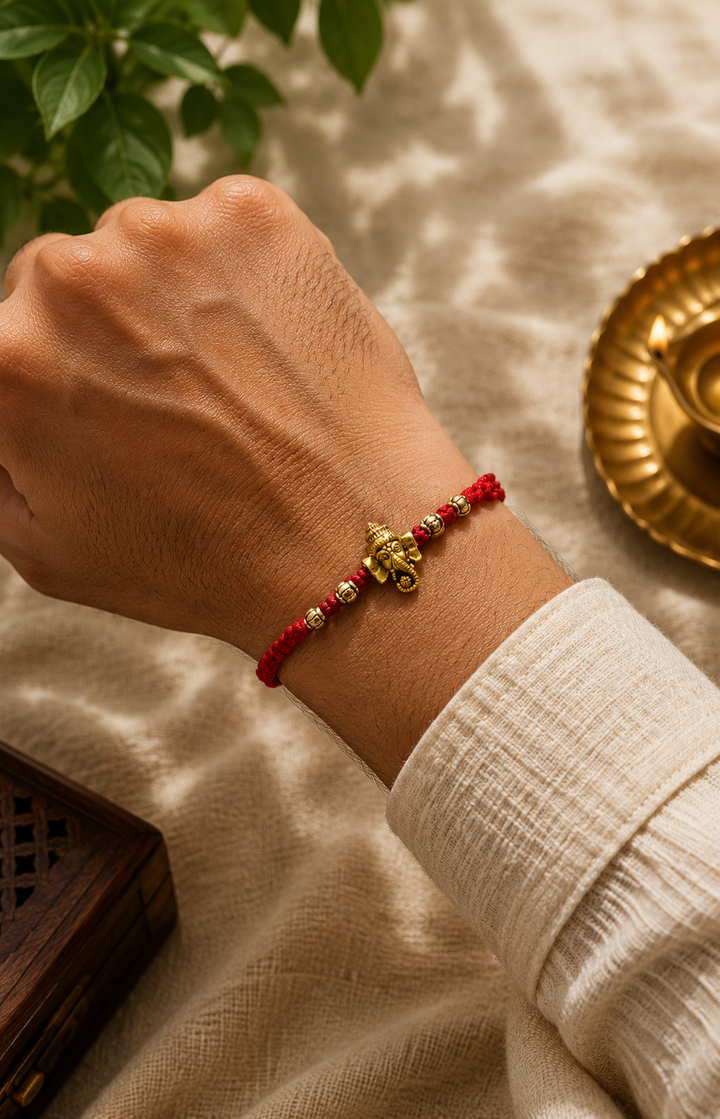Ganesh Om rakhi in mauli thread with rice, haldi & kum kum dibbi gift pack.